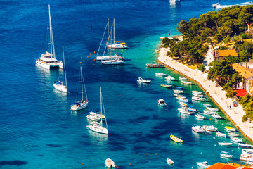 View at amazing archipelago with boats in front of town Hvar, Croatia. Harbor of old Adriatic island town Hvar. Popular touristic destination of Croatia. Amazing Hvar city on Hvar island, Croatia. - obrazy, fototapety, plakaty