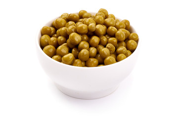 Marinated green peas in a bowl, close-up, isolated on white background. Pickled peas