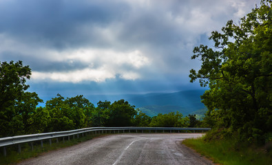 Storm Clouds over a winding road
