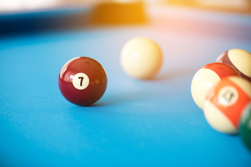 pool or billiards balls on light blue table , focus on lucky number 7