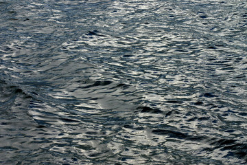 Background from gray river waves in windy cloudy weather