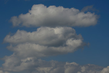 Fototapeta na wymiar Cottony clouds, cumulus clouds, in a blue sky