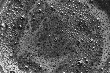 macro photo foam on coffee closeup top view, black and white photography