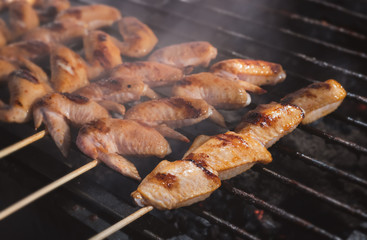 Grilled skewer chicken meat with charcoal flame.