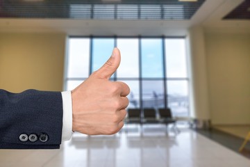 Businessman showing thumbs up  over blue background