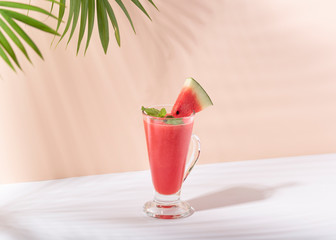Fresh water melon juice and watermelon slice on color background. summer drink.