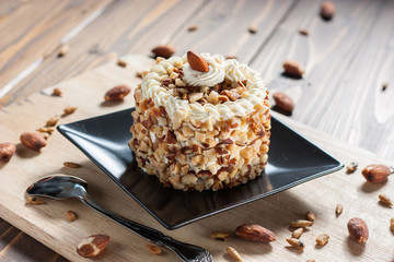 round almond cream cake on wood background