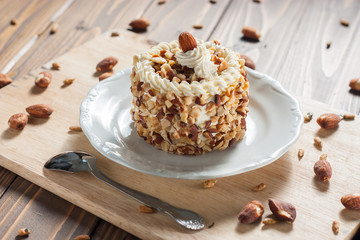 round almond cream cake on wood background