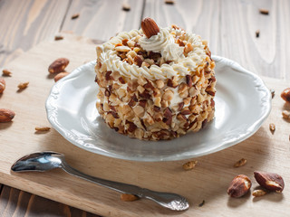 round almond cream cake on wood background