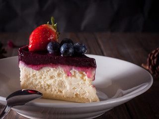 Blueberry cheesecake decorate with pinecorn and dry flower on wood board