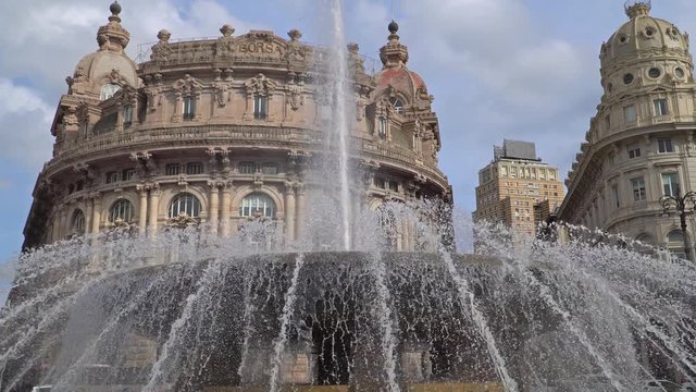 Genoa, Liguria, Italy - CIRCA 2019: Genova fountain Piazza de Ferrari. The famous fountain and the surrounding buildings at Piazza De Ferrari in Genoa In the background the Ducal Palace.