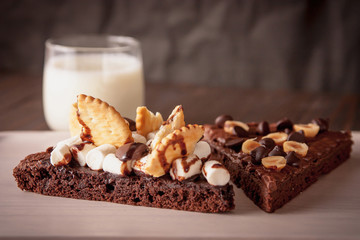 chocolate cake with marshmallows , cut on wooden board