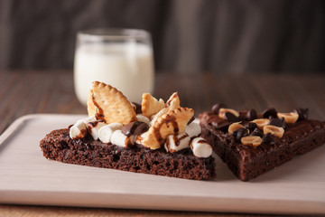 chocolate cake with marshmallows , cut on wooden board