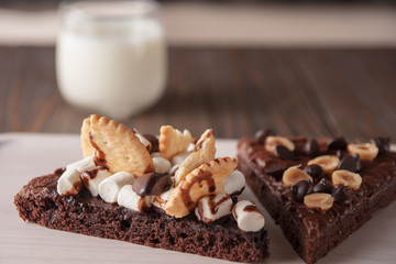 chocolate cake with marshmallows , cut on wooden board