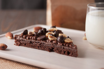 chocolate cake with marshmallows , cut on wooden board