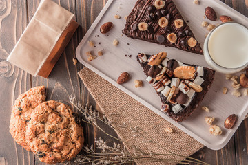chocolate cake with marshmallows , cut on wooden board