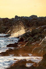 Sunset skies at the jetty as waves crash over the rocks