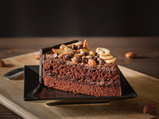 Sweet chocolate cake topping with chocolate and almond nut decor
