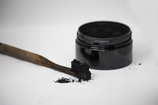 Charcoal on a toothbrush to whiten teeth