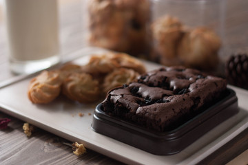chocolate brownie and cookies on wood background