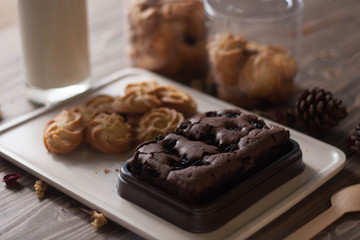 chocolate brownie and cookies on wood background
