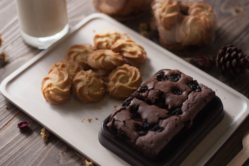 chocolate brownie and cookies on wood background