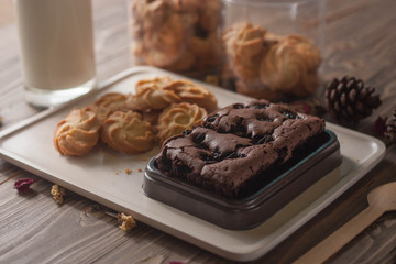 chocolate brownie and cookies on wood background