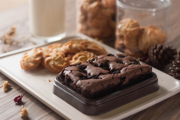 chocolate brownie and cookies on wood background