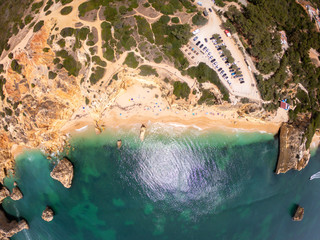 Top view on coast of Atlantic Ocean, beach and cliffs in Praia de Marinha, Algarve Portugal