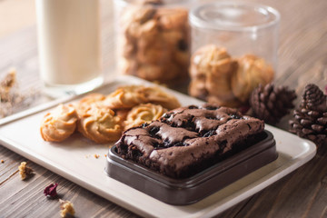 chocolate brownie and cookies on wood background