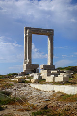 Obraz premium Iconic and unique Temple of Apollon or Portara (Gate) with breathtaking views to port - town and castle of Naxos island and the Aegean blue sea, Cyclades, Greece