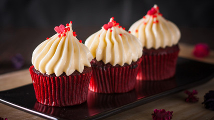 red velvet cupcakes with cream cheese icing decorate with dry fl