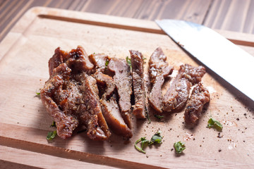 Charcoal-boiled pork neck and sauce on a wooden floor .Grilled Pork thailand style