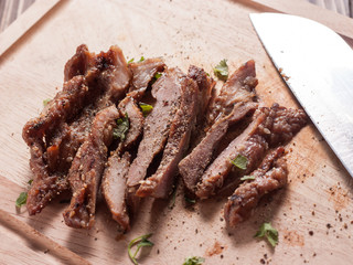 Charcoal-boiled pork neck and sauce on a wooden floor .Grilled Pork thailand style