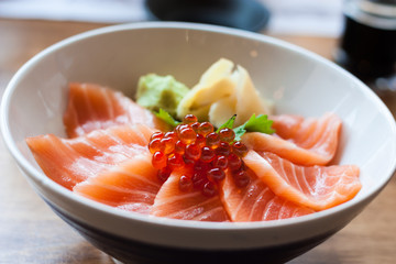 salmon sashimi put into white bowl