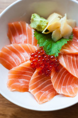salmon sashimi put into white bowl