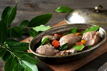 chicken drumsticks stewed with bay leaf. laurel as an aromatic spice in a dish.