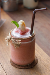 Lychee smoothie with pieces of lychee on Wood table