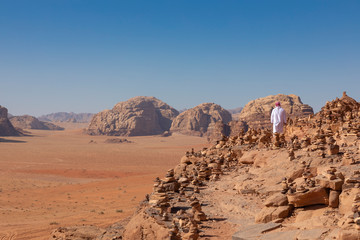 Bedouin and Panoramic view of the Red Desert in Wadi Rum, Jordan, Middle East.