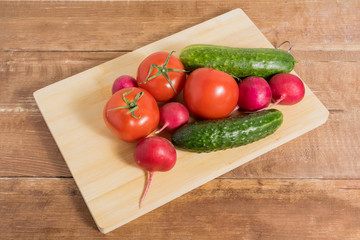 Tomatoes, pills and radishes on a wooden background.
