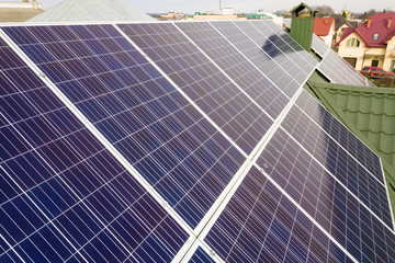 Close-up surface of blue shiny solar photo voltaic panels system on building roof. Renewable...
