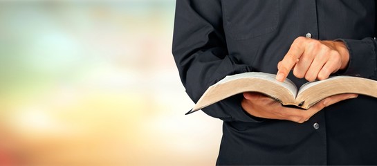 Man reading Bible on  background