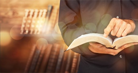 Man reading Bible on  background