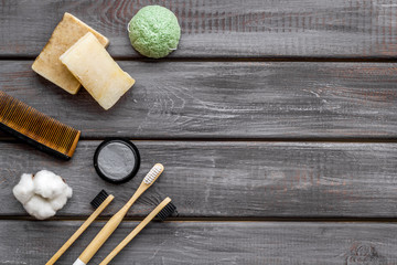 Eco materials concept with bamboo tooth brush and toothpaste with bamboo carbon on wooden background top view copy space