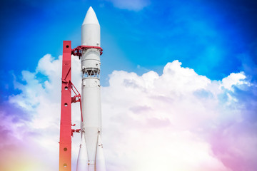 Russian spaceship on a background of blue sky with clouds. The concept of cosmonautics in the USSR. Copy space