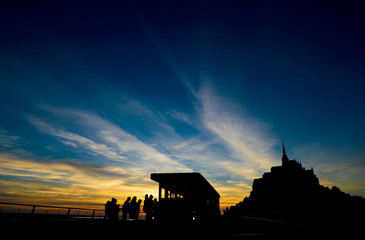 Silhouette of Mont Saint michele at night with people