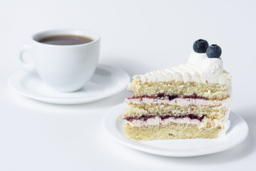Blueberry cheesecake slice with tea front view on a white background