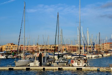 Obraz premium Various yachts and boats in the Corralejo harbour. Harbor located on the northern tip of Fuerteventura.