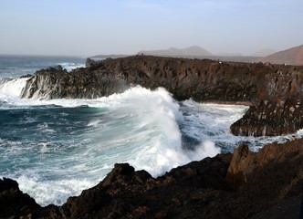 Fototapeta na wymiar Volcanic coastal landscape with huge waves on the Atlantic Ocean. Los Hervideros, Lanzarote, Canary Islands, Spain
