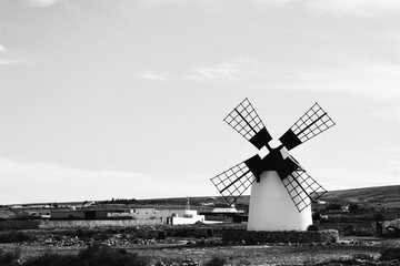Black and white photo. Single windmill somewhere in the middle of Fuerteventura island. Canary Island, Spain